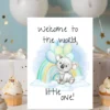 Charming baby shower card with a watercolor koala sitting on a cloud, surrounded by balloons and a rainbow, welcoming a little one.