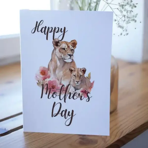 Printable card for Mother's Day showcasing a lioness and blooming flowers, celebrating the strength of mothers.