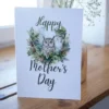 Charming watercolor owl on a printable Mother's Day card, set against a tranquil forest scene.
