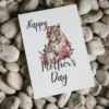 Sweet illustration of a tiger and her cub on a printable Mother's Day card, perfect for celebrating moms.