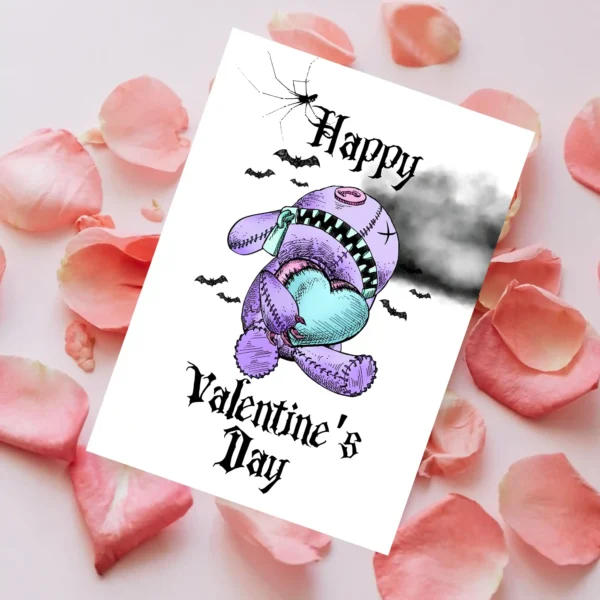 Happy Valentine's Day card with a pastel goth teddy bear holding a heart, set against dark clouds and bats.