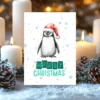 Christmas penguin greeting card with “Merry Christmas” message and falling snow