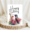 Beautiful purple hummingbird birthday card in watercolor style, adorned with flowers, perfect for a heartfelt birthday greeting.