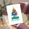 Printable holiday card featuring a rainbow Christmas tree and snowy winter scene