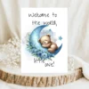 Watercolor card featuring a bear on a blue moon with the message, "Welcome to the world, little one!" for new babies.