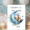 Sweet watercolor card with a bear on a blue moon, reading, "Welcome to the world, little one!" for celebrating new arrivals.