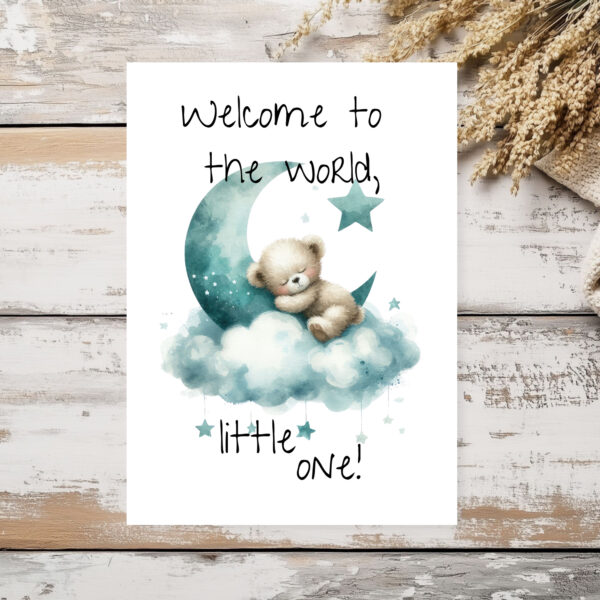 Charming watercolor illustration of a bear on a moon with clouds, featuring the message "Welcome to the world, little one!"