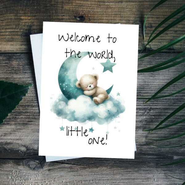 Watercolor card featuring a sleepy bear on a moon, surrounded by clouds, with the message "Welcome to the world, little one!"
