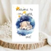 Adorable watercolor card showing a puppy napping on a cloud, with stars and the text "Welcome to the world, little one!"