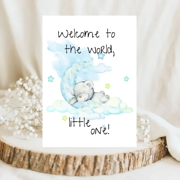 Printable new baby card with a pastel teddy bear on the moon, saying, "Welcome to the world, little one!"