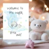 Adorable new baby card with a pastel teddy bear on the moon, featuring the message, "Welcome to the world, little one!"
