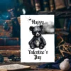A Valentine's Day card depicting a black bear on a marble table, combining Gothic elements with a playful, creepy vibe.