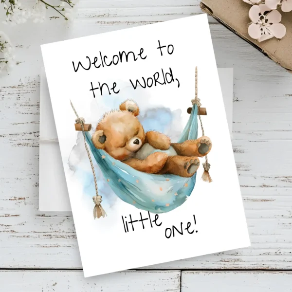 Cute watercolor card showing a teddy bear in a blue hammock, celebrating a new baby with the text, "Welcome to the world!"