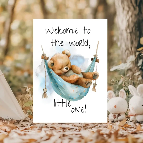 Adorable card with a sleepy teddy bear in a blue hammock, featuring the message, "Welcome to the world, little one!"