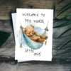 Charming watercolor illustration of a teddy bear in a hammock, accompanied by the words, "Welcome to the world, little one!"