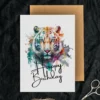 Printable birthday card showcasing a joyful tiger in watercolor, bursting with color for a festive touch.