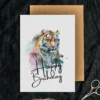 Happy birthday card with a joyful tiger illustration in watercolor, set against a soft pastel background.