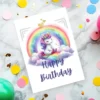 Sleepy unicorn sitting on a rainbow card