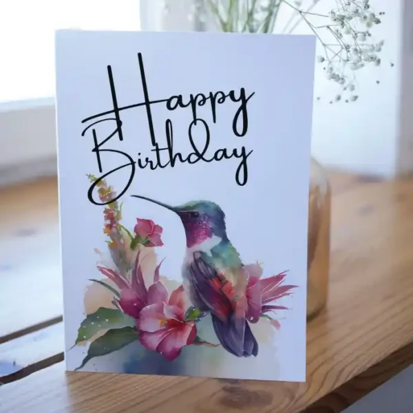 Watercolor birthday card with a purple hummingbird and flowers, ideal for sending warm wishes on someone's special day.