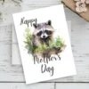 Charming watercolor raccoon on a printable Mother's Day card, surrounded by woodland themes and a loving message.