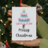 Festive transgender card with a pink and blue watercolor Christmas tree, designed to spread joy and inclusivity during the holidays.