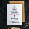 Merry Christmas card displaying a transgender tree in pink, blue and white watercolor, celebrating love and diversity in a festive design.