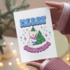 Printable Christmas card featuring a cheerful polar bear with a festive design celebrating Transgender pride.