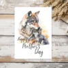 Watercolor illustration of a wolf mother and her pup on a Mother's Day card, conveying warmth and love.