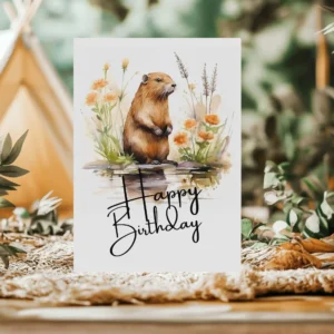 Colorful birthday card with a joyful beaver in a natural scene, adorned with a "Happy Birthday" greeting.