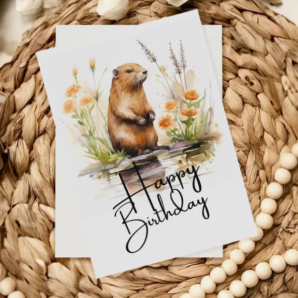Delightful birthday card with a smiling beaver in a natural setting, featuring a cheerful "Happy Birthday" text.