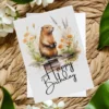 Charming birthday card depicting a happy beaver in a watercolor environment, complete with a "Happy Birthday" wish.