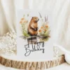 Happy birthday card featuring a cheerful beaver in a watercolor natural setting with a festive message.