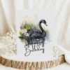 Watercolor birthday card featuring a black swan in a natural setting with a cheerful "Happy Birthday" message.