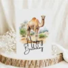 Watercolor birthday card featuring a cheerful camel in a natural setting with a "Happy Birthday" message.