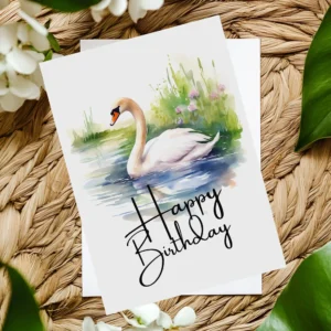 Watercolor illustration of a swan on a birthday card, surrounded by nature, featuring a festive "Happy Birthday" message.