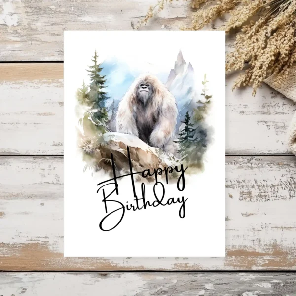 Delightful Yeti birthday card with a watercolor scene, featuring a friendly "Happy Birthday" message for a special celebration.