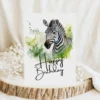 Watercolor zebra birthday card in a natural setting with a cheerful "Happy Birthday" message.